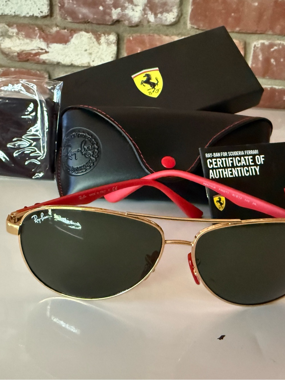 Ray-Ban Ferrari Gold Frame Sunglasses with Black Lenses and Red Temples